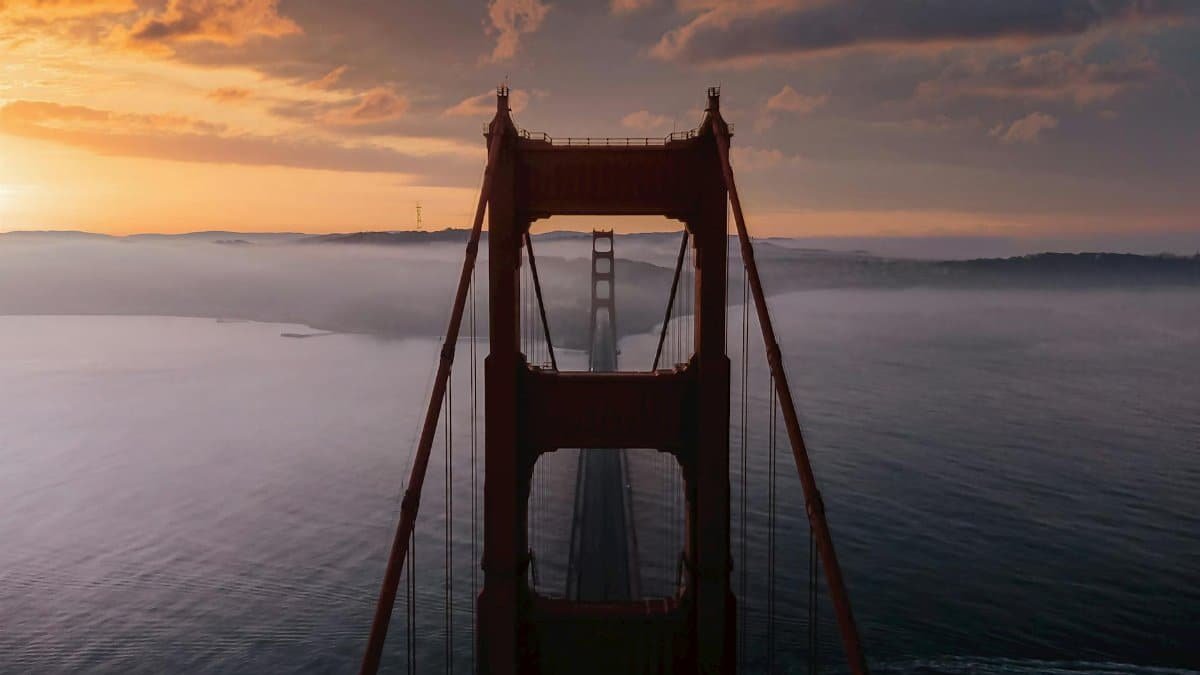 Stunning aerial view of the Golden Gate Bridge at sunrise over San Francisco Bay.