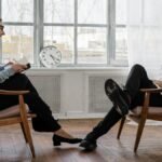 Counselor and client in a positive therapy session in a well-lit room.