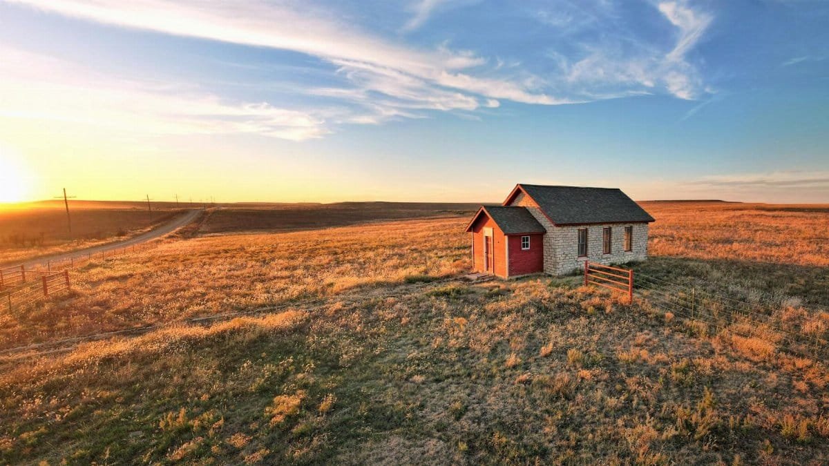A charming rural cottage in the sunset-lit plains of Eureka, Kansas.