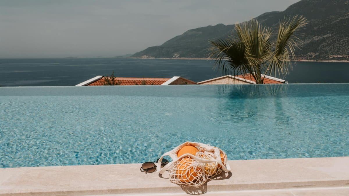 Serene infinity pool with ocean view in Antalya, Turkey, perfect for a summer getaway.