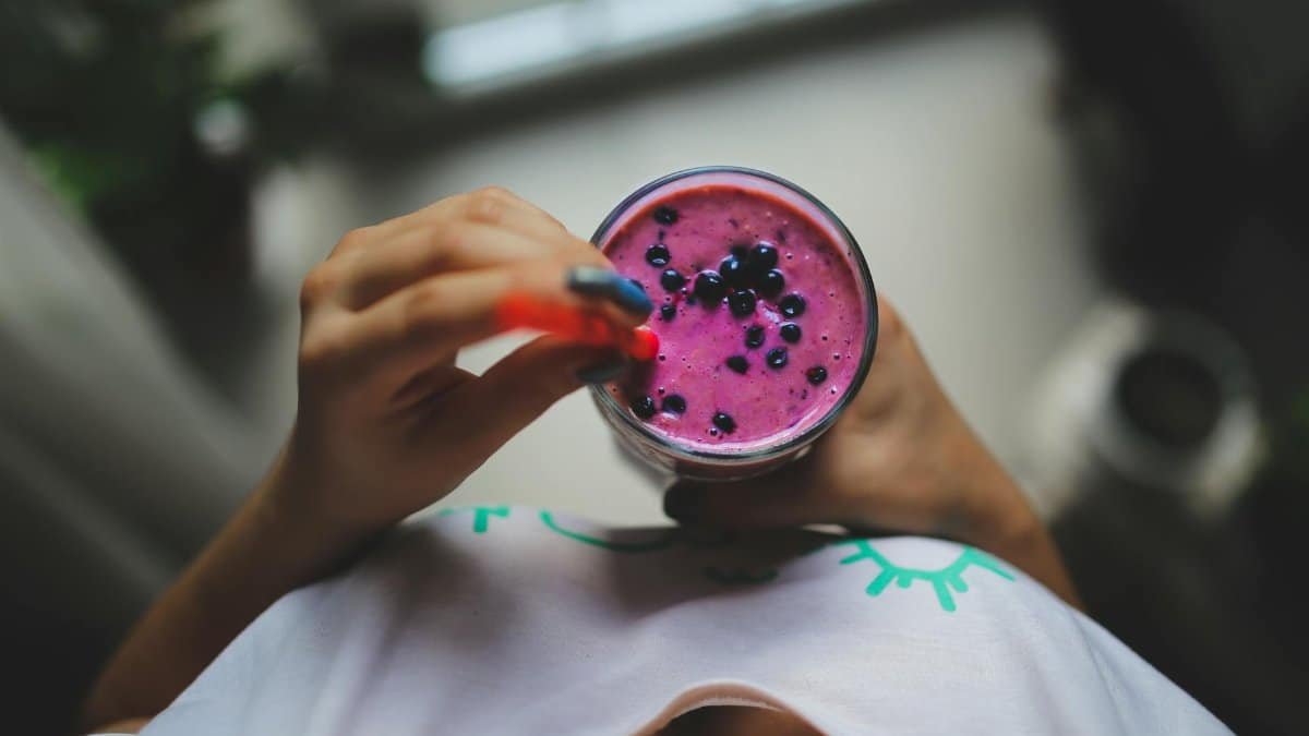 Enjoy a healthy and vibrant blueberry yogurt smoothie with a pop of color, perfect for a nutritious lifestyle.