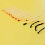 Symbolic representation of burnout using matches on a yellow background, illustrating exhaustion.