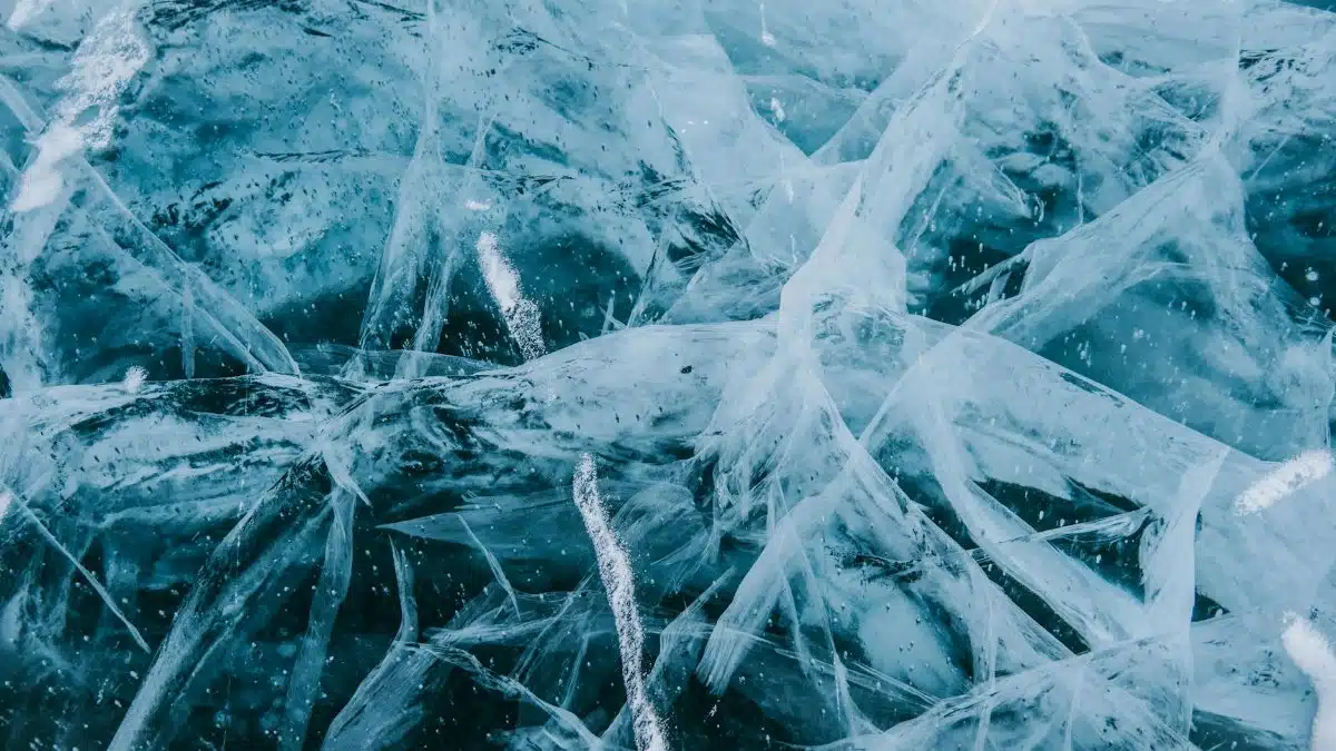 Detailed view of cracked ice patterns in Siberia showcasing intricate frozen structures.