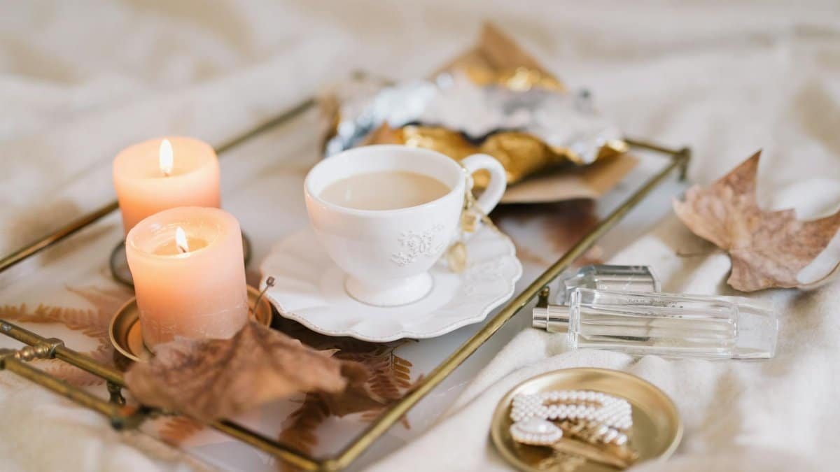Enjoy a relaxing autumn morning ambiance with tea, candles, and cozy decor.