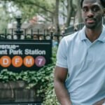 Two people chatting near 5 Avenue-Bryant Park subway entrance in NYC.