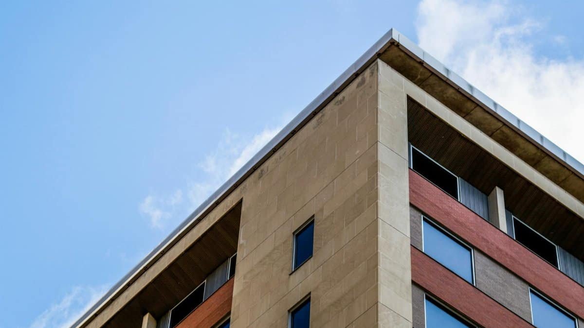 Low angle view of a modern building facade with glass windows against a clear sky in Minneapolis.