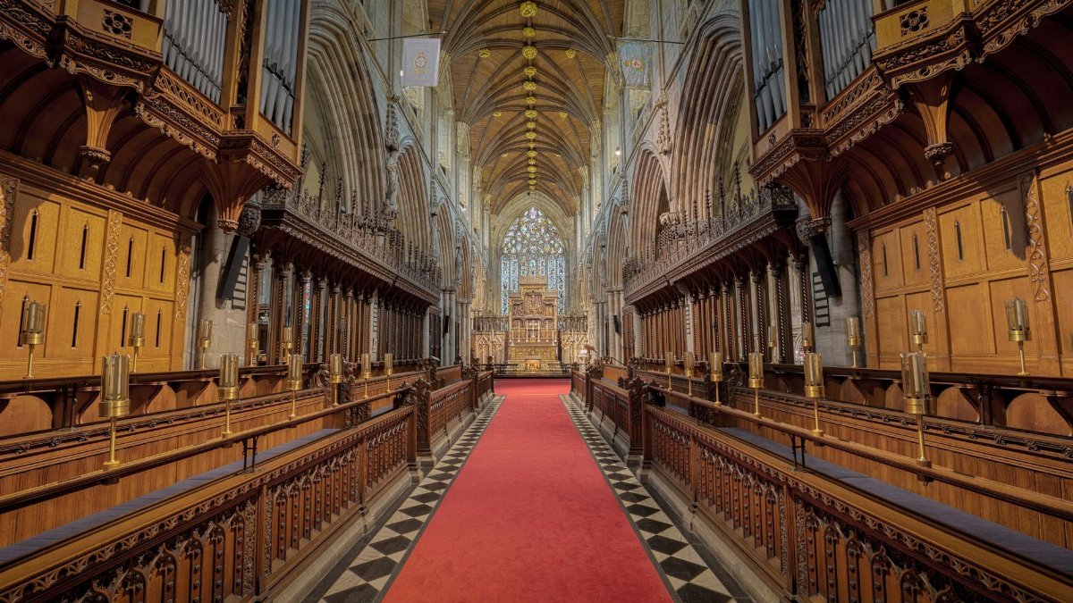 Beautiful interior of Selby Abbey featuring Gothic architecture and vibrant red carpet.