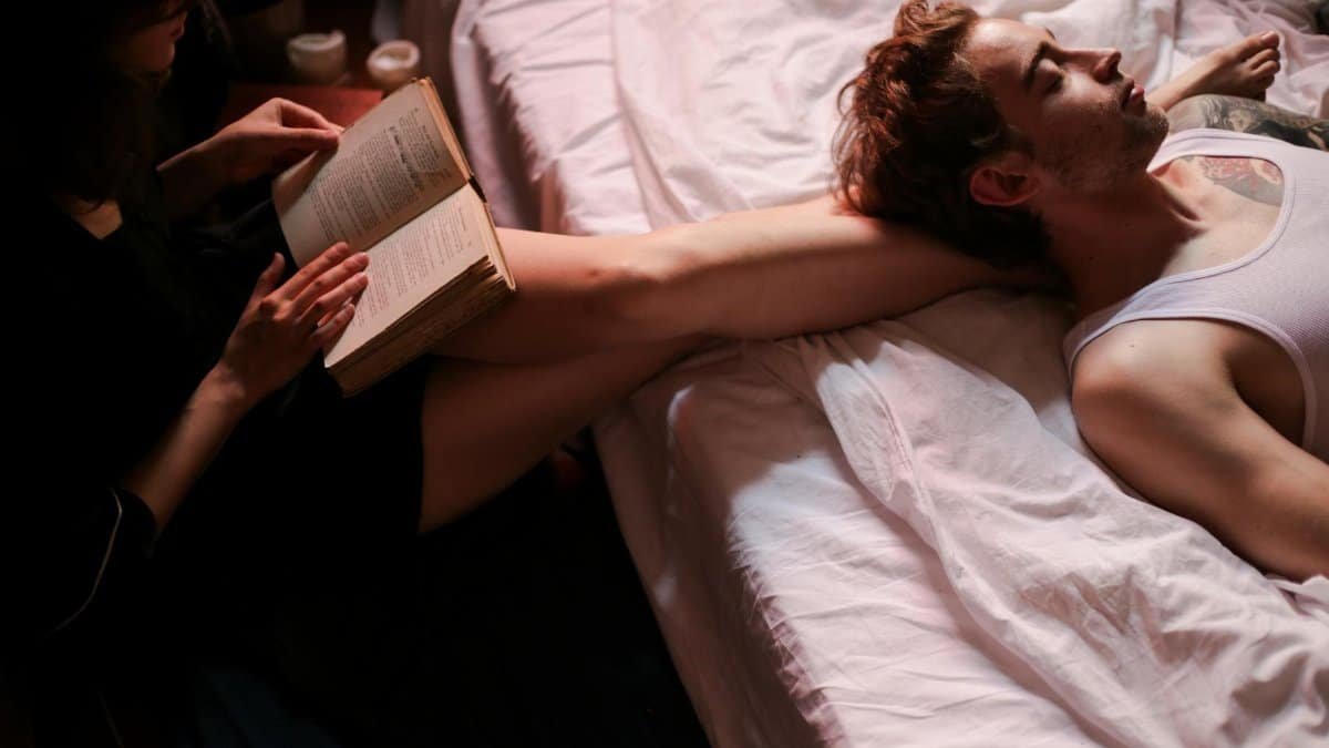 A couple enjoying a quiet moment together, reading in bed.
