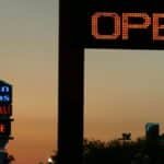 Neon signs light up the evening sky in Kissimmee, Florida. Vibrant nightlife is evident.