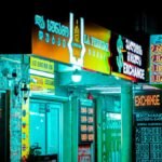 Night view of a brightly lit storefront and currency exchange signs in Batumi, Georgia.