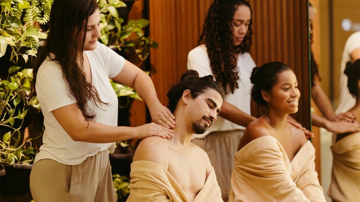 Men and women enjoying relaxing massages at a spa, surrounded by greenery, promoting wellness and relaxation.