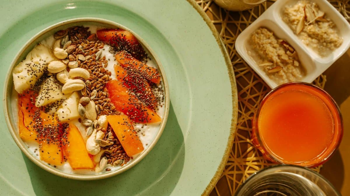 A vibrant breakfast bowl with yogurt, fruits, and seeds, perfect for a healthy morning start.