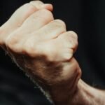 A close-up image of a clenched fist, symbolizing strength and determination.