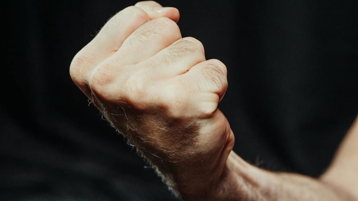 A close-up image of a clenched fist, symbolizing strength and determination.