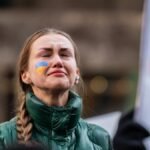 A powerful portrait of a woman at a protest in New York City, expressing deep emotion and determination.