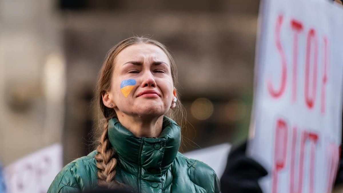 A powerful portrait of a woman at a protest in New York City, expressing deep emotion and determination.