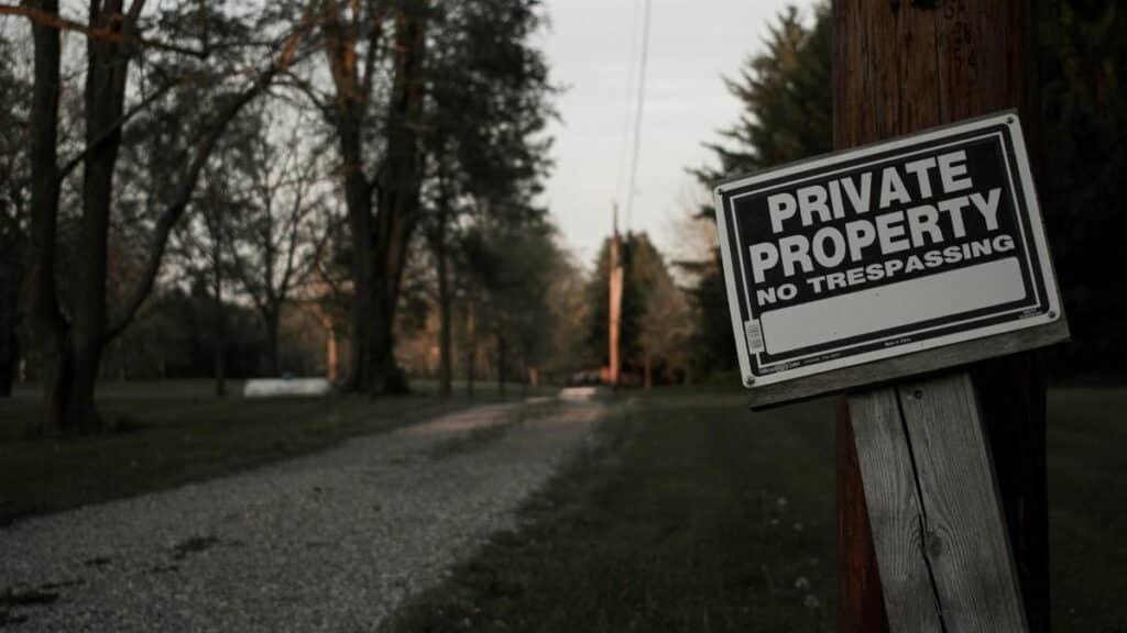 A 'private property, no trespassing' sign on a wooden post along a rural road in Ohio.