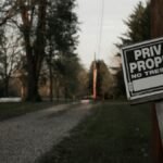 A 'private property, no trespassing' sign on a wooden post along a rural road in Ohio.