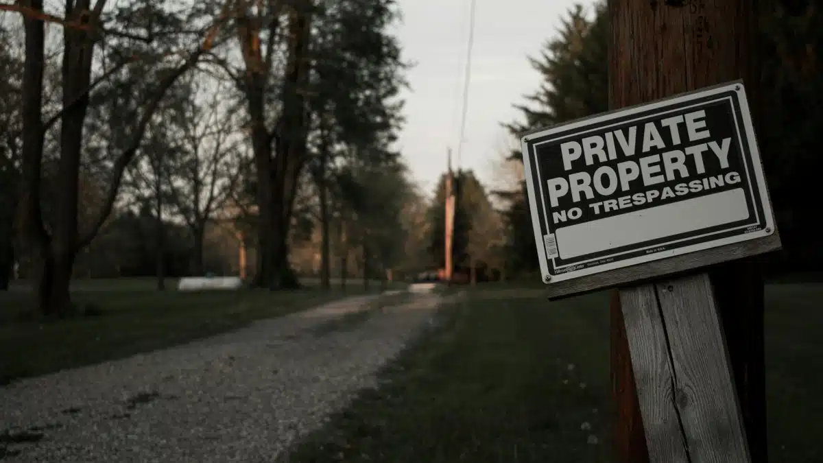 A 'private property, no trespassing' sign on a wooden post along a rural road in Ohio.