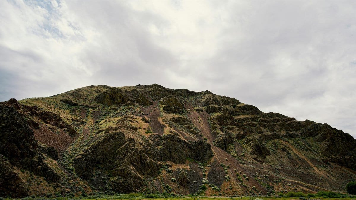 Beautiful mountain scene with rugged terrain under a cloudy sky, perfect for nature and travel themes.