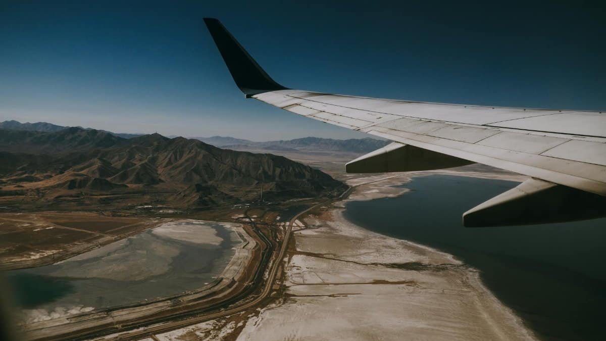 Stunning aerial view of Salt Lake City, Utah, with mountains and Lake, seen from an airplane at sunset.