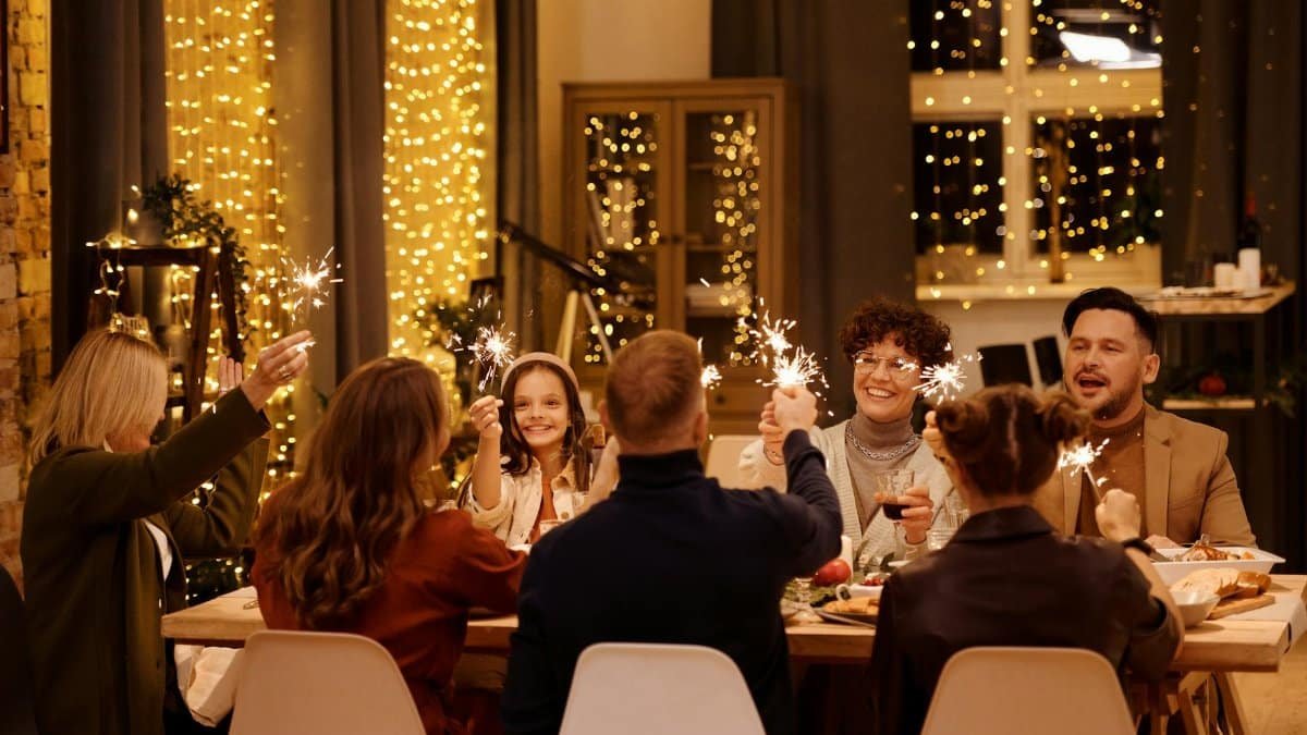 A cheerful family dinner with sparklers, creating a festive atmosphere.