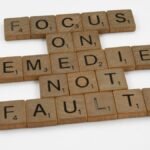 Scrabble tiles spelling an inspirational message on focus and problem-solving.