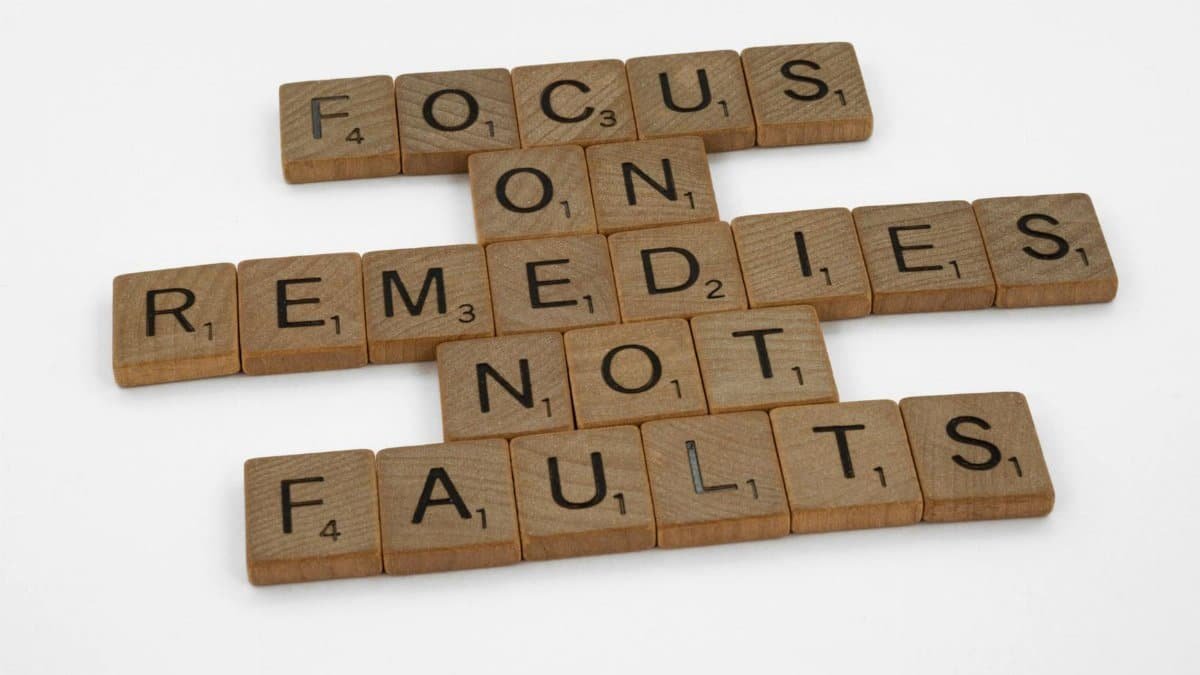 Scrabble tiles spelling an inspirational message on focus and problem-solving.