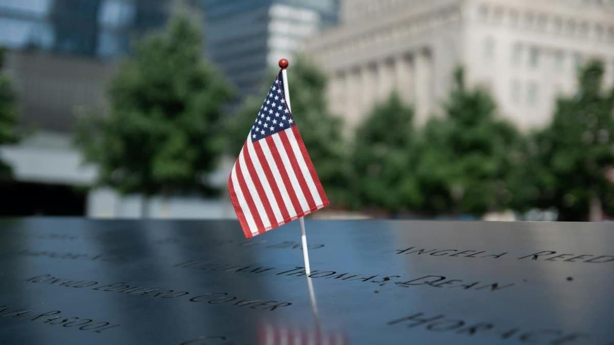 American flag at the 9/11 Memorial in NYC, symbolizing remembrance and patriotism.