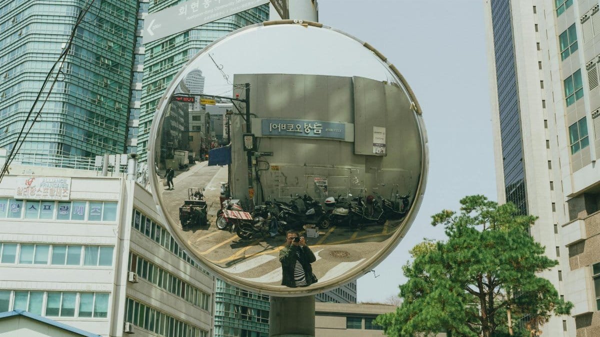 A captivating street scene reflection in a convex mirror in downtown Seoul, South Korea.