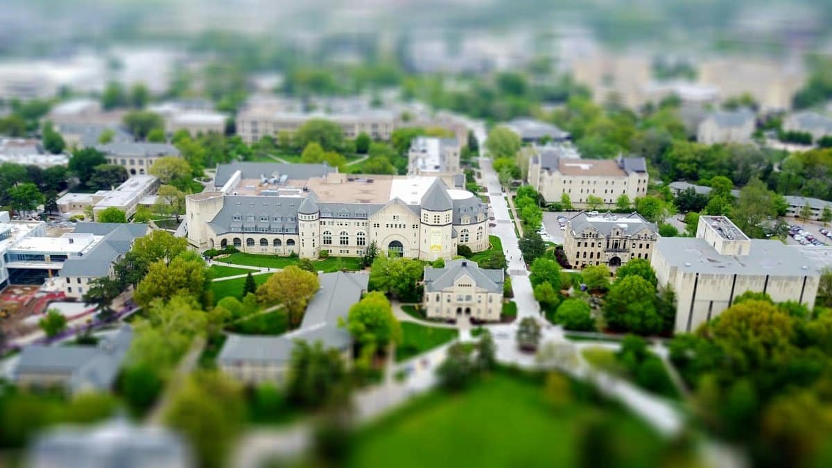 Aerial view of the Kansas State University campus in Manhattan, KS with green spaces and historic buildings.
