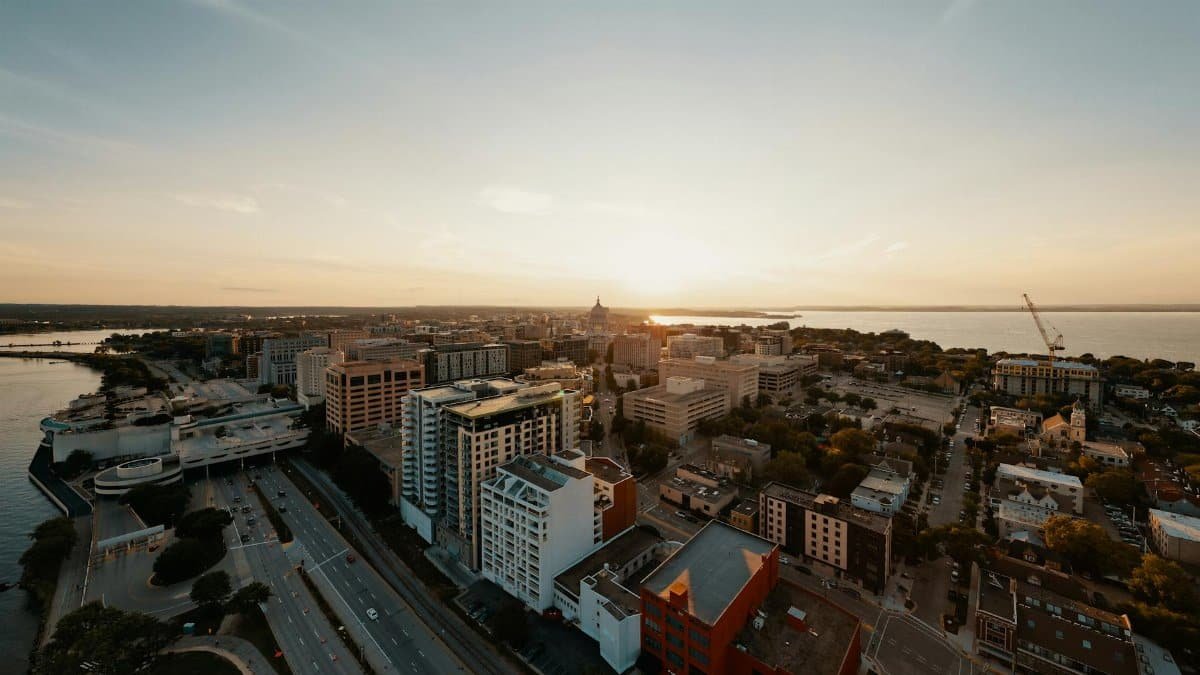 Breathtaking aerial view of Madison, Wisconsin's cityscape during a serene sunset.