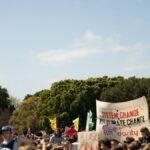 Crowd holding signs at a climate change protest in Sydney, Australia.