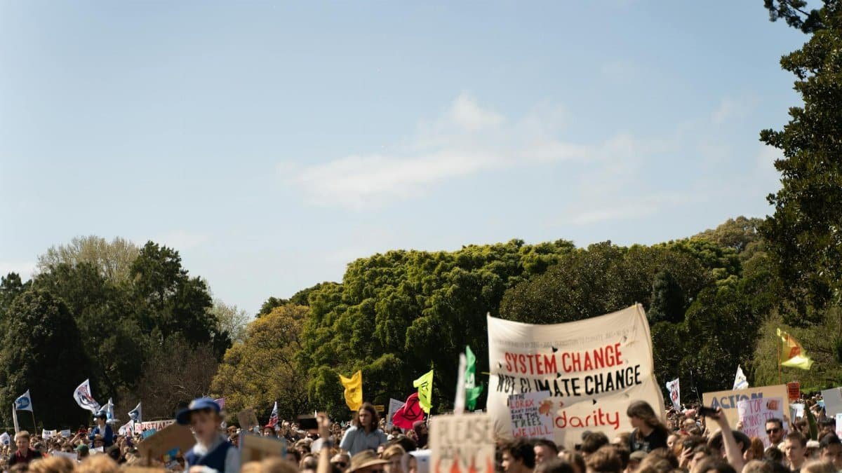 Crowd holding signs at a climate change protest in Sydney, Australia.