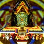 Vibrant projection on woman depicting mystical patterns and spiritual symbols.