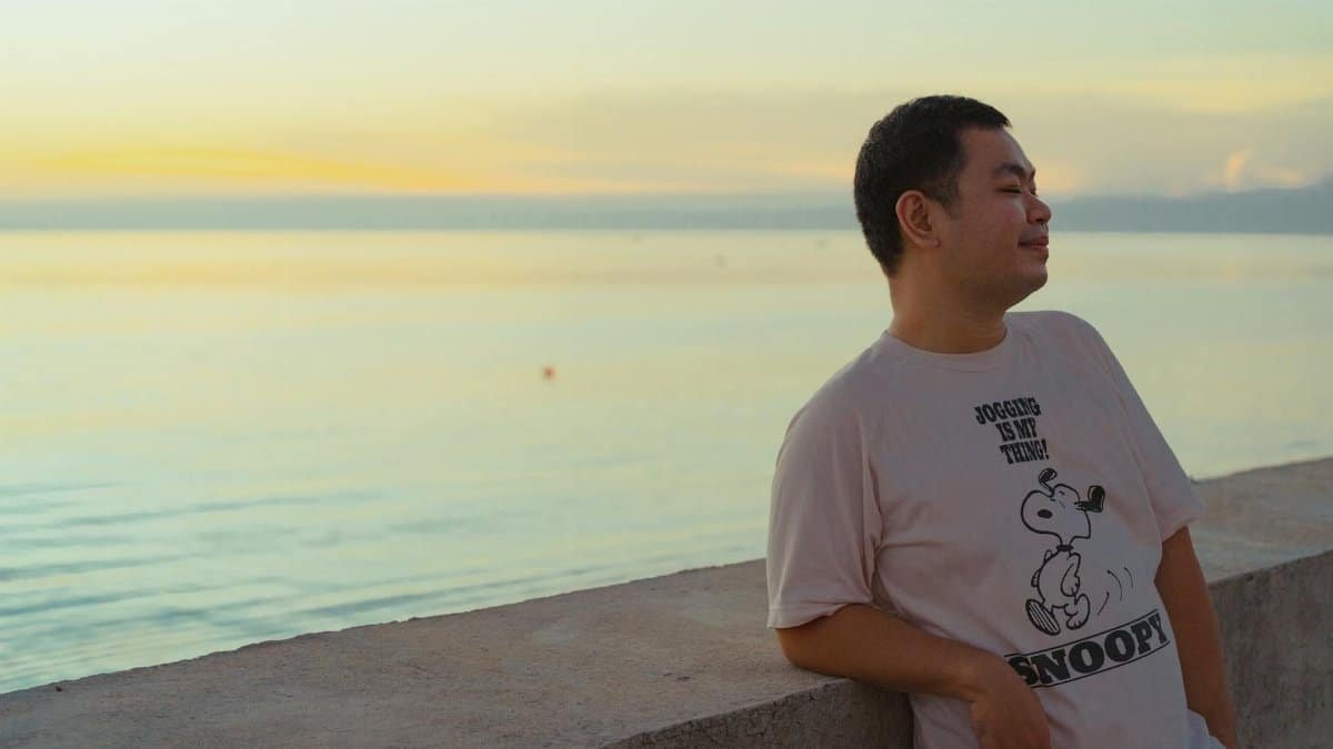 Man enjoying a peaceful sunset by the sea in Bình Thuận, Vietnam.