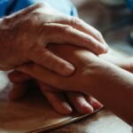 Close-up of supportive hands showing love and care. Ideal for themes of empathy and bonding.