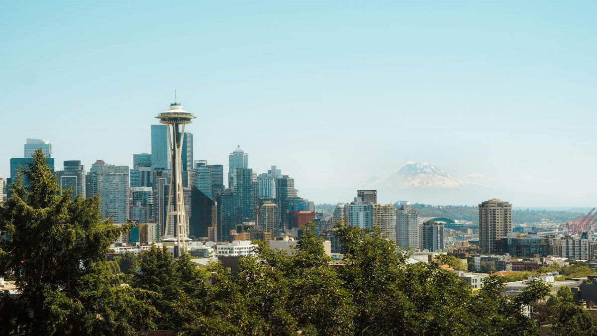 A stunning view of Seattle's skyline featuring the Space Needle and Mount Rainier in the distance.