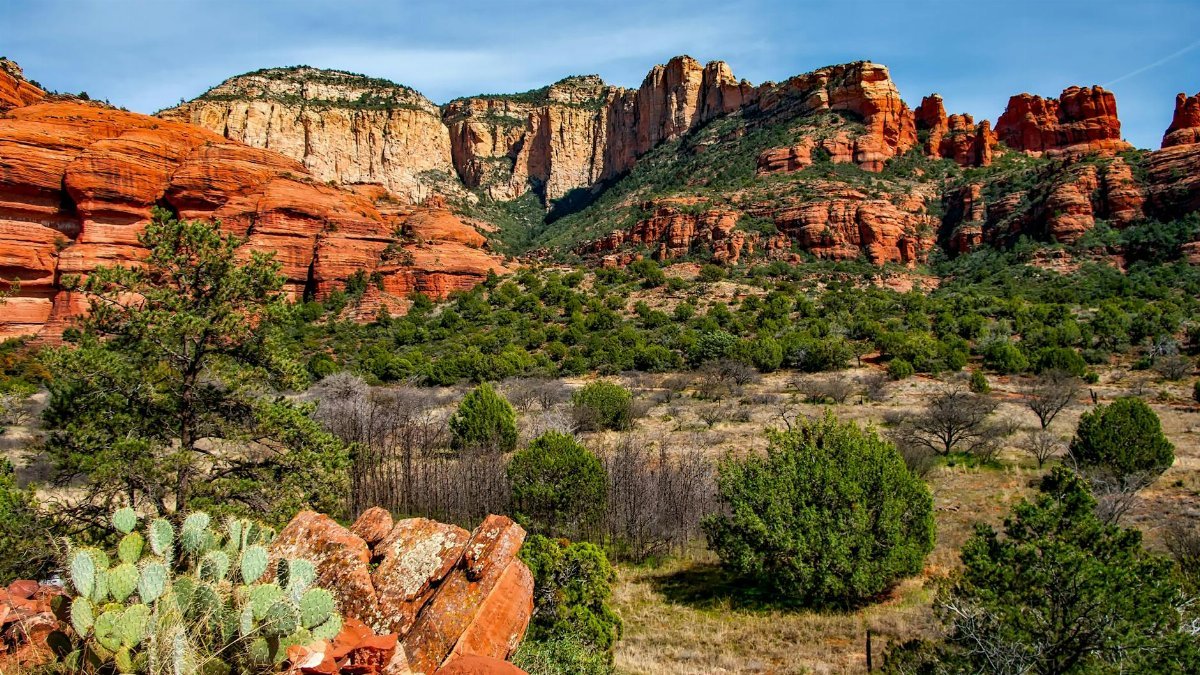 Breathtaking view of red rock formations and lush greenery in Sedona, Arizona.