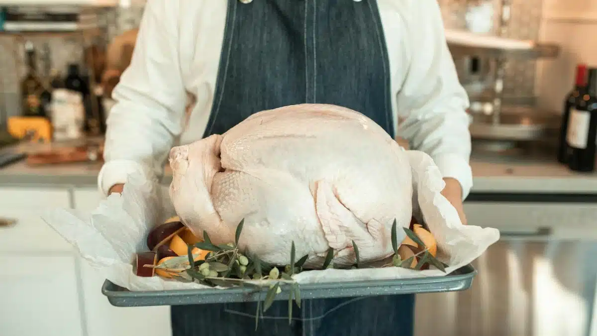 A fresh turkey on a tray, ready for cooking, embodies the Thanksgiving spirit indoors.