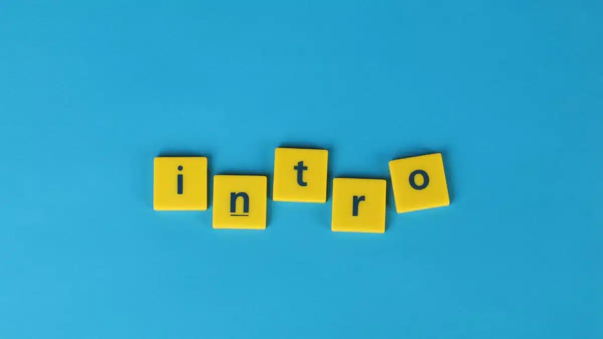 Yellow letter tiles spell 'intro' on a vibrant blue background, ideal for creative projects.