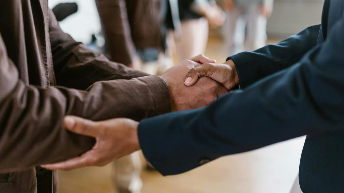 Close-up of two businesspeople shaking hands, symbolizing agreement and partnership.