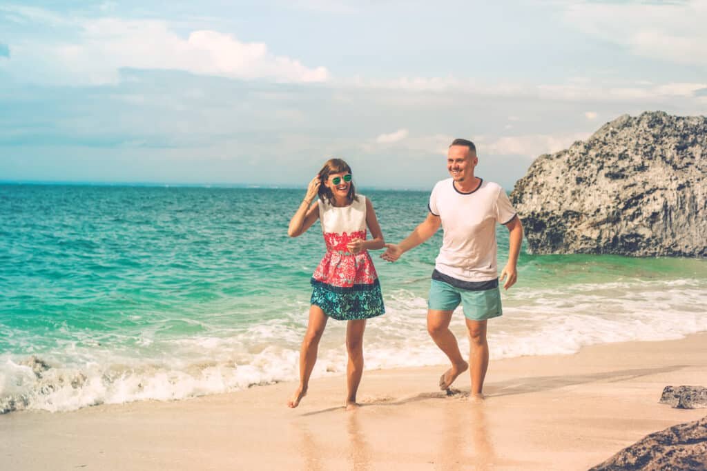 By Artem Beliaikin from Moscow, Russia - Happy young honeymoon couple having fun on the beach. Ocean, tropical vacation on Bali island, Indonesia., CC BY 2.0, https://commons.wikimedia.org/w/index.php?curid=105333228