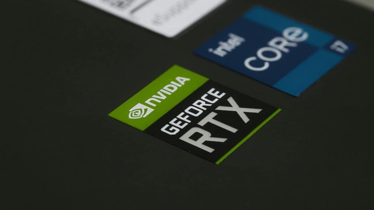 Close-up of NVIDIA GeForce RTX and Intel Core i7 stickers on a laptop surface, showcasing modern technology.