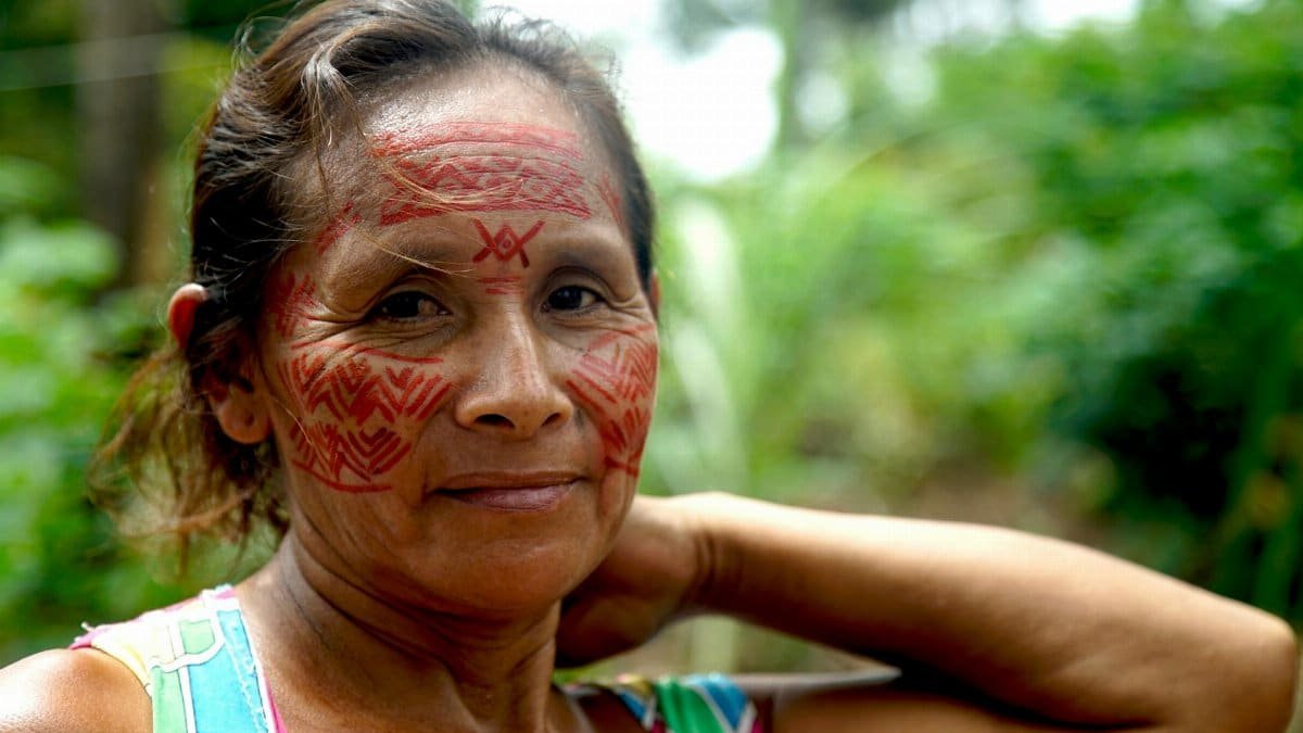 Portrait of an Amazonian tribeswoman with traditional face paint, symbolizing cultural heritage in Manaus, Brazil.