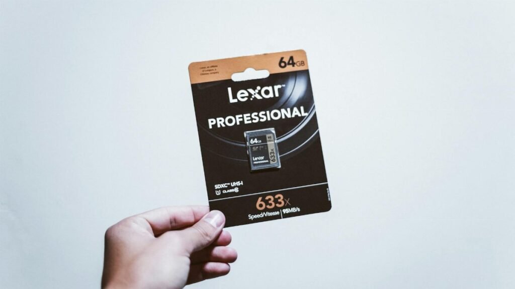 A hand holding a packaged 64GB Lexar Professional SD card, ideal for digital storage.