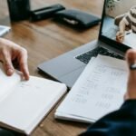 A professional conducting an online class through a video call with a student.