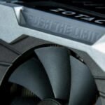 Detailed image of a graphics card with metal cooling fans and branding.