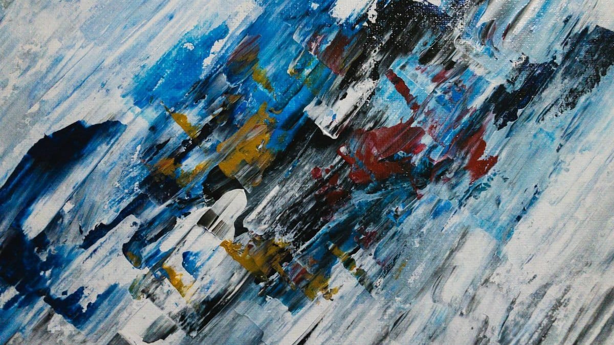 Vibrant abstract acrylic painting showcasing dynamic brushwork in blues, reds, and yellows.