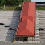 High angle aerial shot of a toll plaza with cars and trucks on an expansive highway.